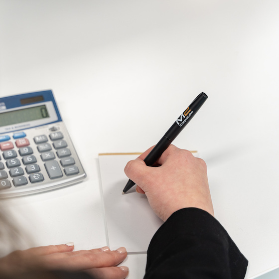 Business accountant writing a note in her notepad