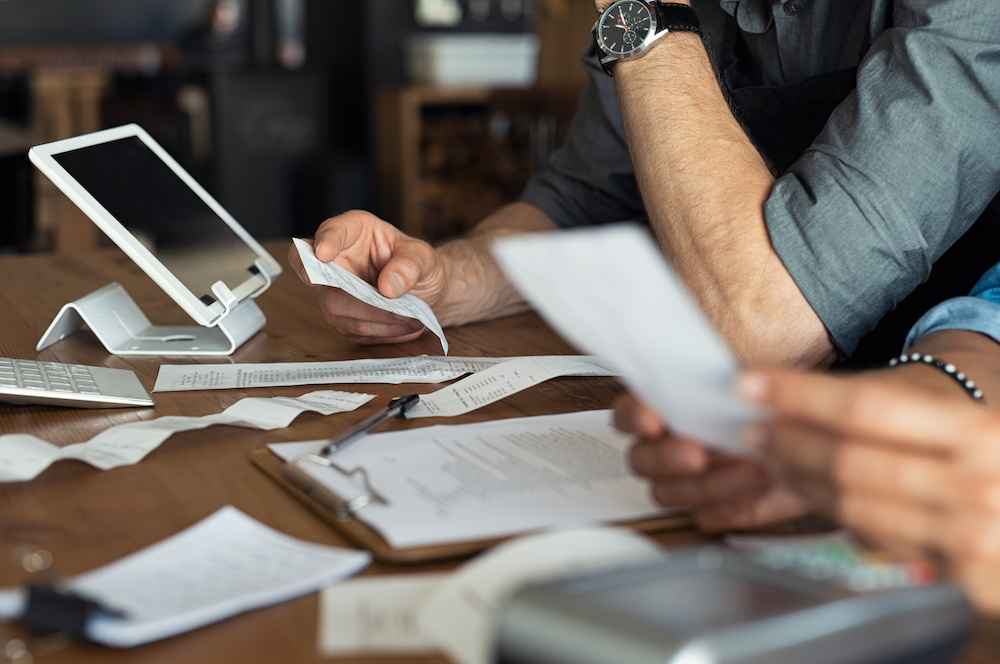 Small business over looking at his bank statements with a small business accountant