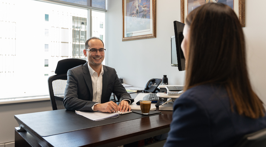 BAS agent sitting at a desk with a client